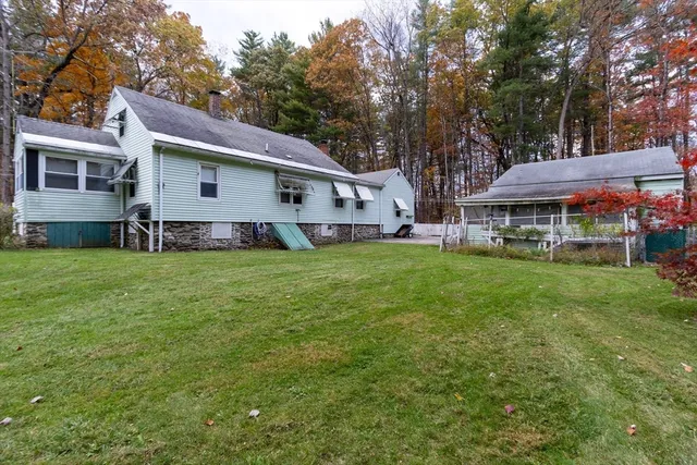 a front view of house with yard and green space