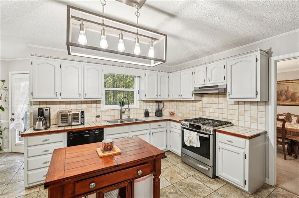 39 Hampton Way Carrollton, GA 30116 - Photo 18 of 57 a kitchen with stainless steel appliances a stove sink microwave and cabinets