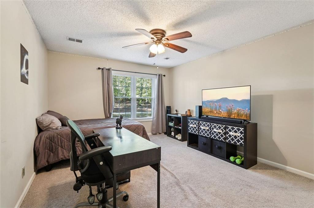 39 Hampton Way Carrollton, GA 30116 - Photo 42 of 57 a living room with furniture and a flat screen tv