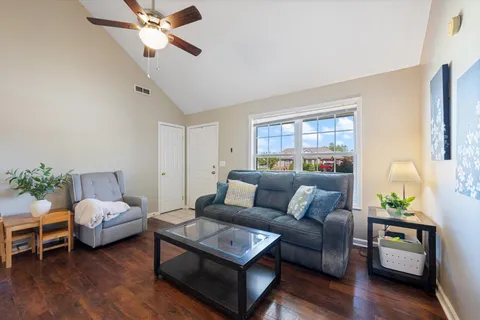 a living room with furniture and wooden floor