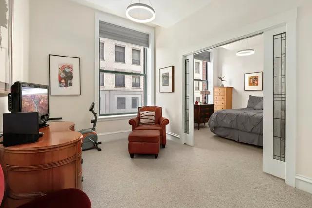 a living room with furniture and a lamp