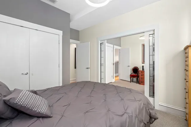 a bedroom with a bed and a mirror