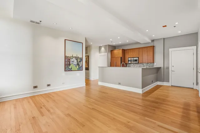 a view of kitchen with wooden floor and electronic appliances