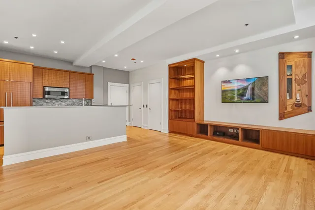 a view of a kitchen with a sink and a refrigerator