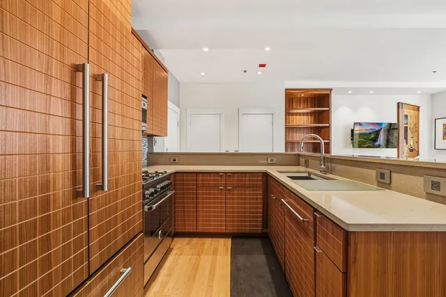 a kitchen with a sink stove and cabinets