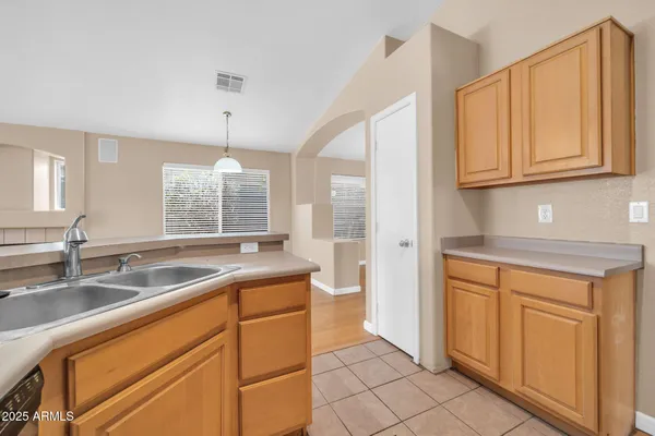 a kitchen with a sink cabinets and stainless steel appliances