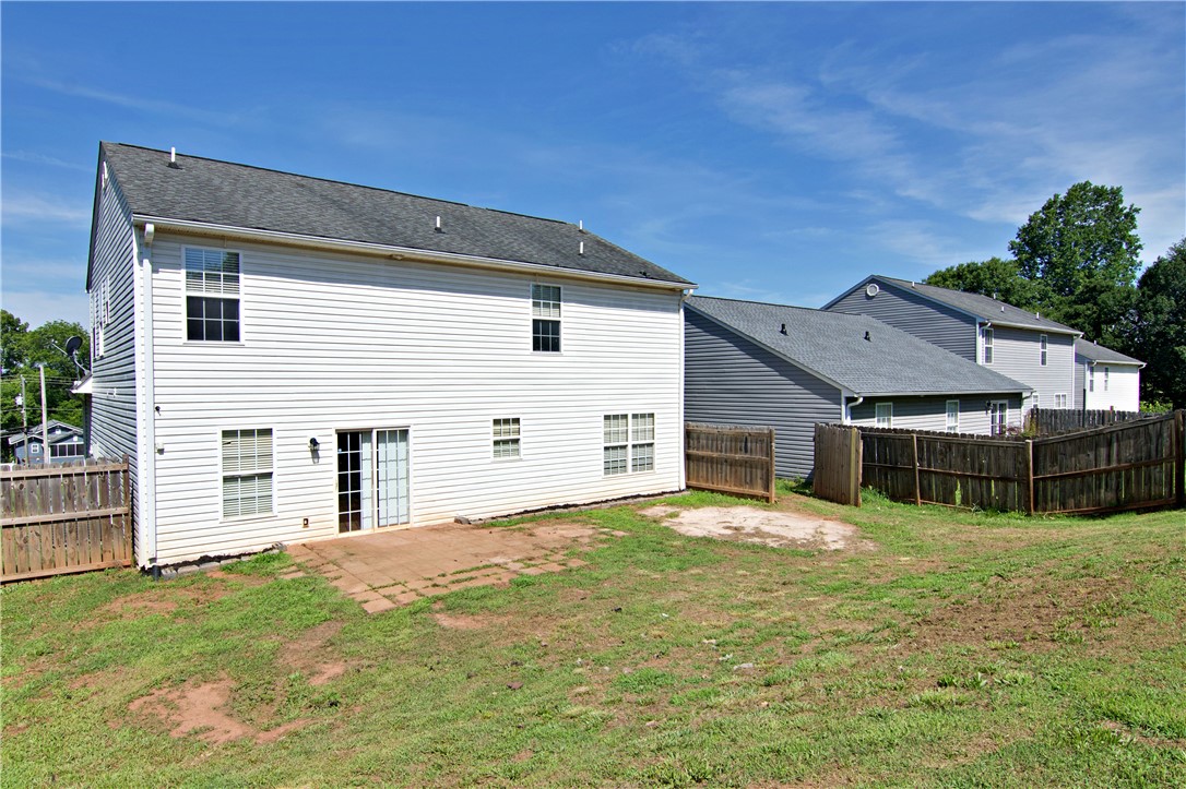 305 North Chestnut Street Seneca, SC 29678 - Photo 39 of 44 A modest rear yard, offering a private outdoor living space, features a compact concrete patio.