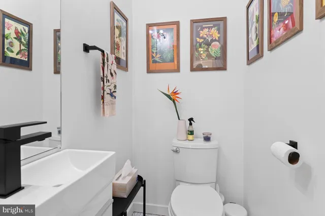 a white toilet sitting next to a bathroom sink