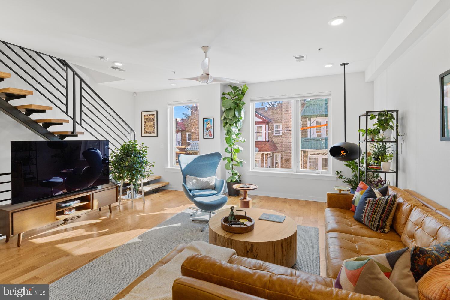 23 East Durham Street, Unit C2 Philadelphia, PA 19119 - Photo 14 of 40 a living room with furniture a flat screen tv and large window