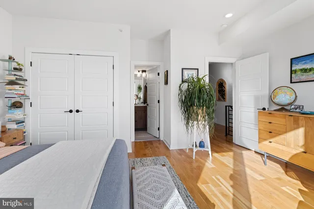 a bedroom with a bed and a potted plant