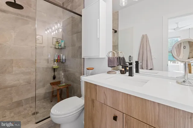 a bathroom with a sink toilet and a mirror