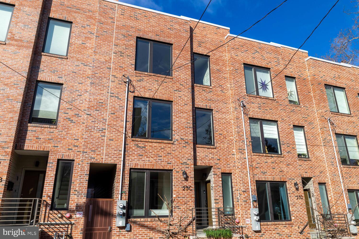 23 East Durham Street, Unit C2 Philadelphia, PA 19119 - Photo 2 of 40 a front view of a brick building with large windows