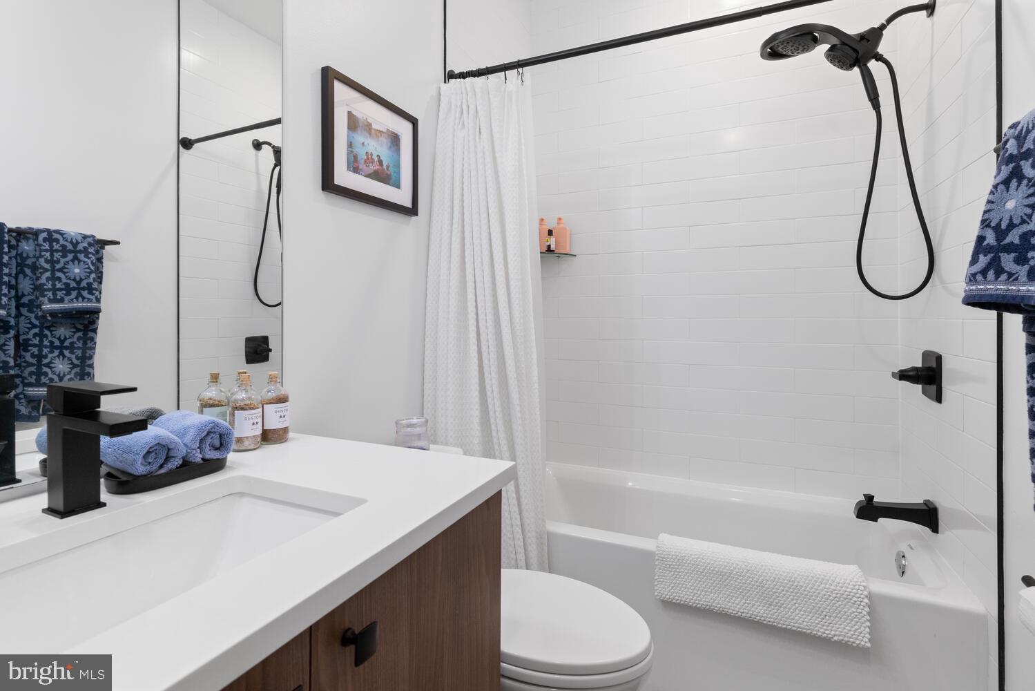 23 East Durham Street, Unit C2 Philadelphia, PA 19119 - Photo 24 of 40 a bathroom with a granite countertop sink a toilet and shower