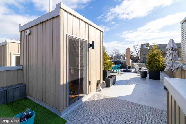 a balcony with wooden floor outdoor seating and city view