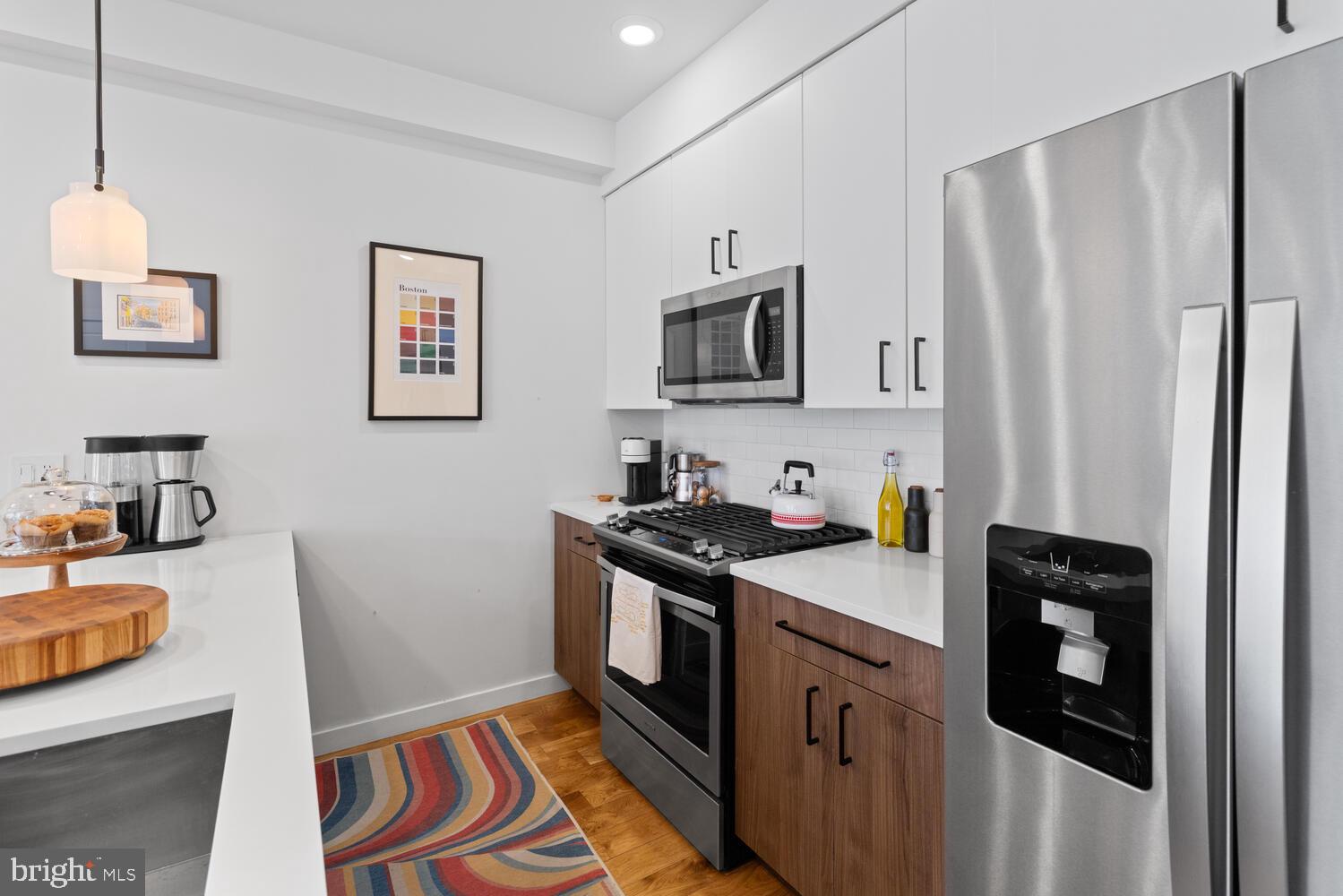 23 East Durham Street, Unit C2 Philadelphia, PA 19119 - Photo 6 of 40 a kitchen with stainless steel appliances granite countertop a refrigerator a stove a sink and a microwave