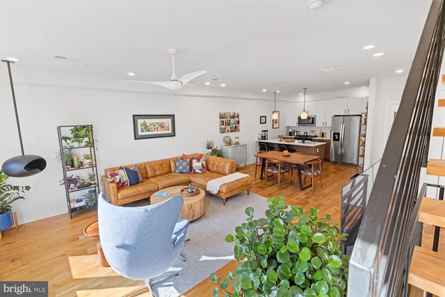 a living room with fireplace furniture and a potted plant