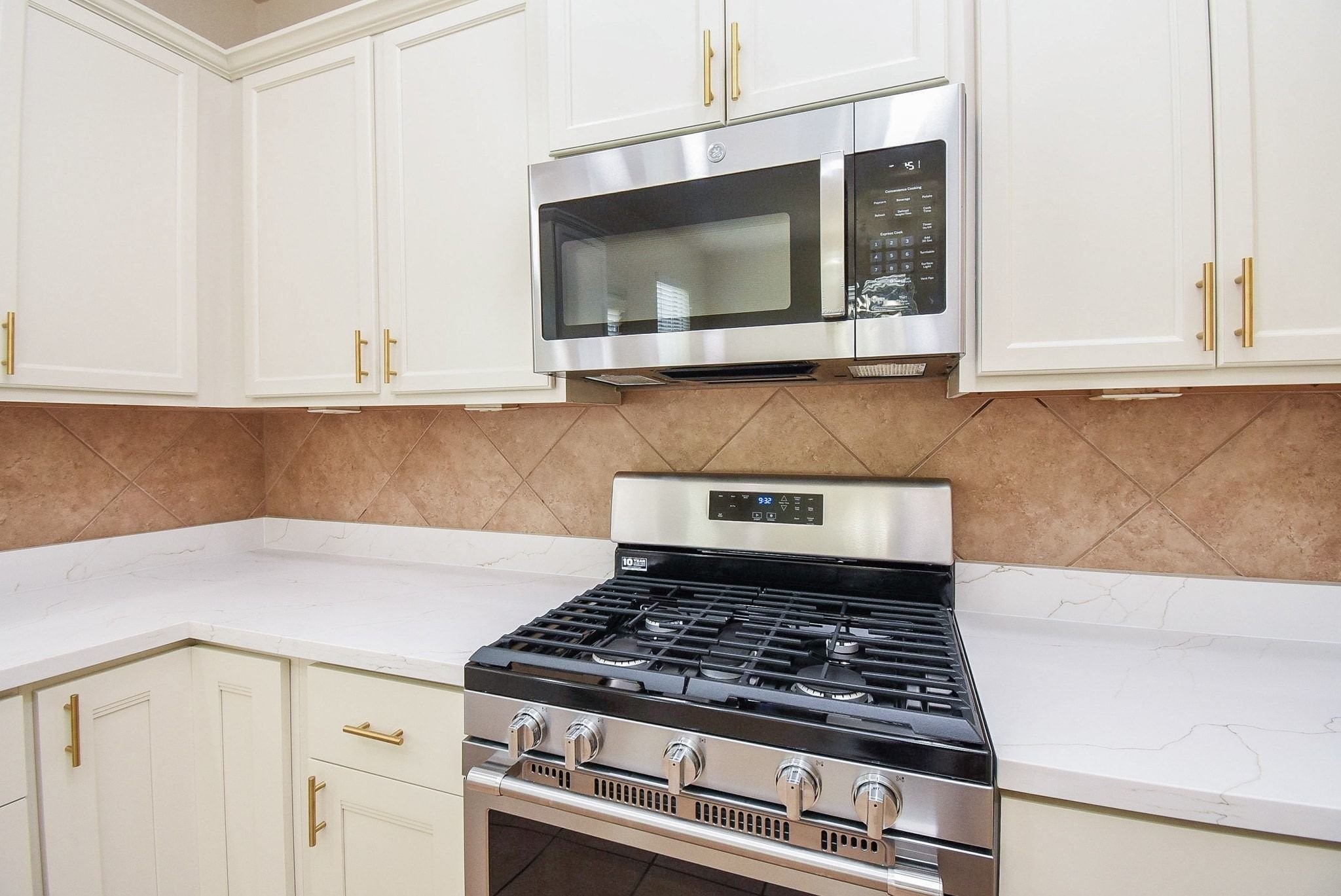 2106 Harmon Crest Court Spring, TX 77373 - Photo 15 of 37 a kitchen with microwave cabinets and stove top oven