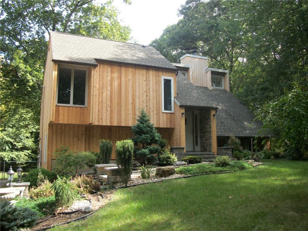 1 Evergreen Drive Clinton, CT 06413 - Photo 1 of 1 a front view of a house with a yard and garage