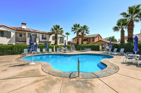 a front view of house with yard and swimming pool