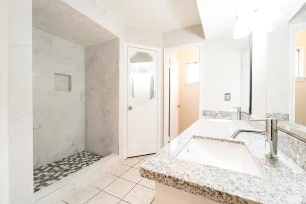 a bedroom with a bed and a mirror