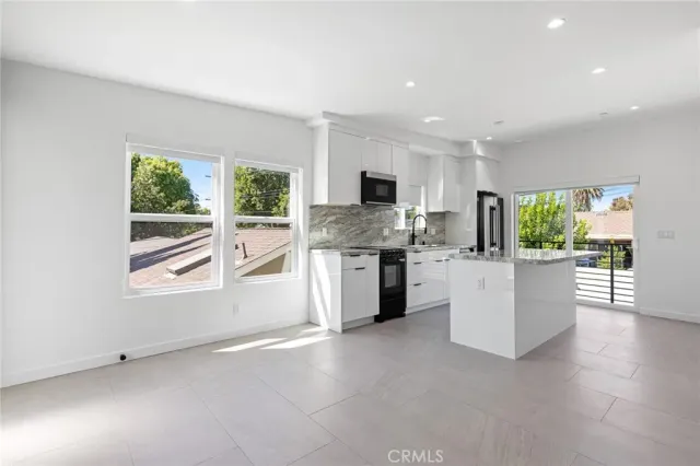 a kitchen with furniture and window