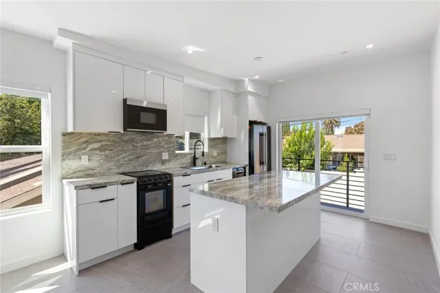 a kitchen with stainless steel appliances granite countertop a stove and a sink