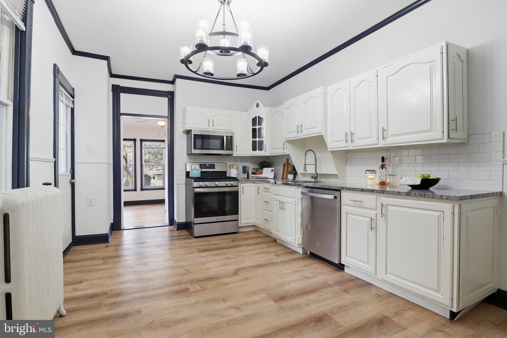 812 South George Street York, PA 17403 - Photo 11 of 58 a kitchen with stainless steel appliances granite countertop a stove top oven a refrigerator a sink and dishwasher with white cabinets