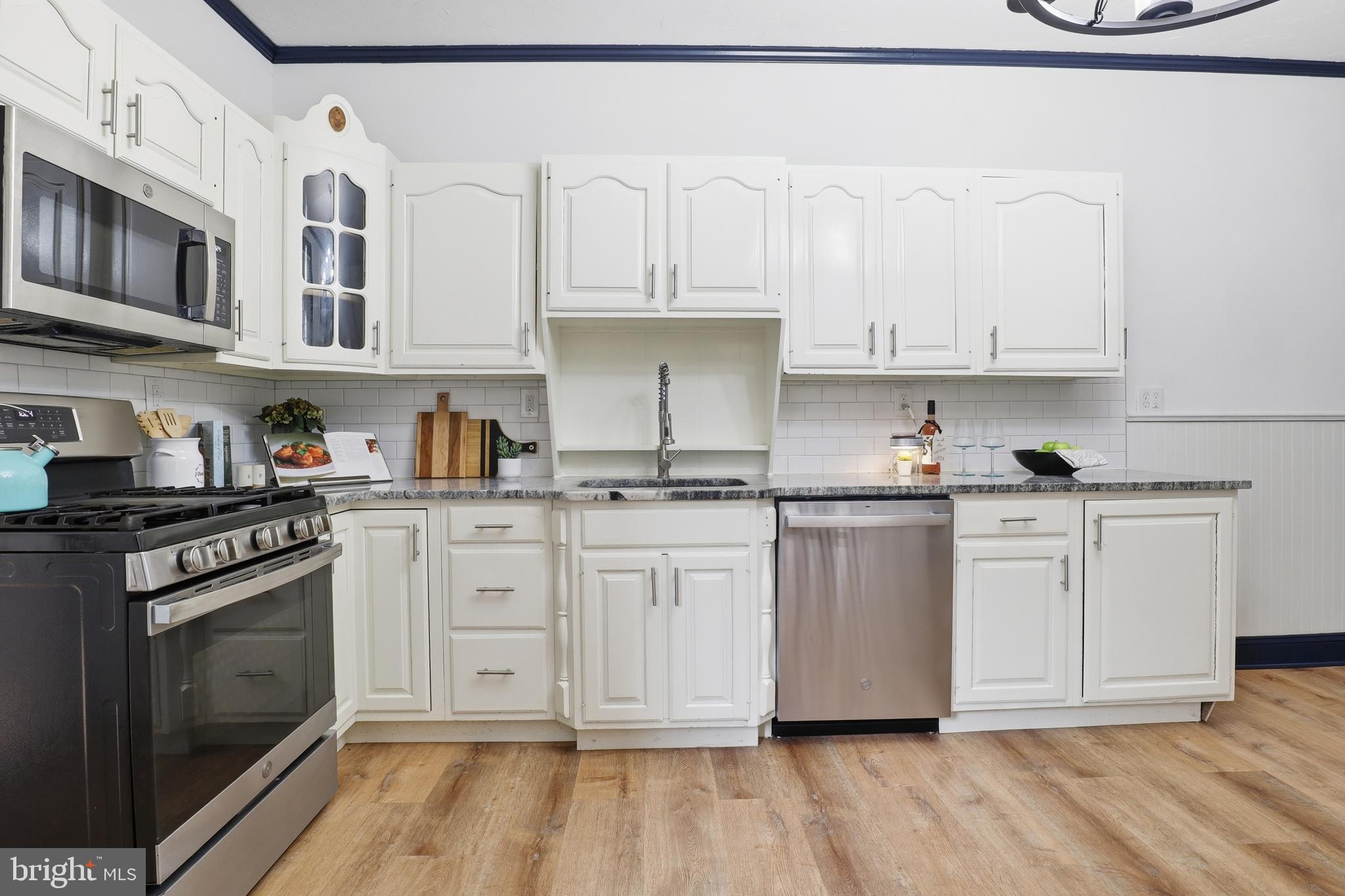 812 South George Street York, PA 17403 - Photo 12 of 58 a kitchen with stainless steel appliances granite countertop a stove a sink and white cabinets