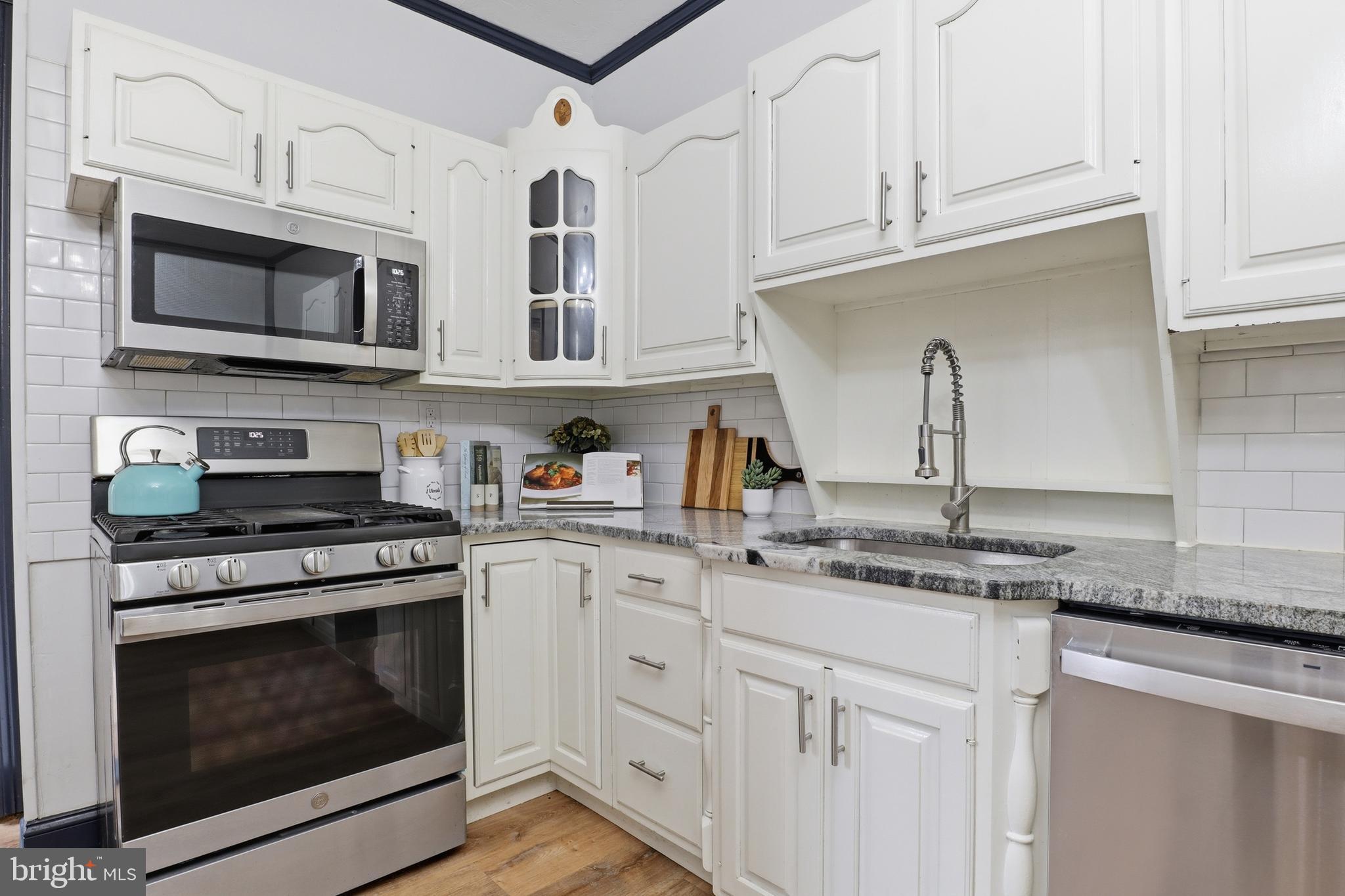 812 South George Street York, PA 17403 - Photo 14 of 58 a kitchen with stainless steel appliances granite countertop white cabinets a sink and dishwasher