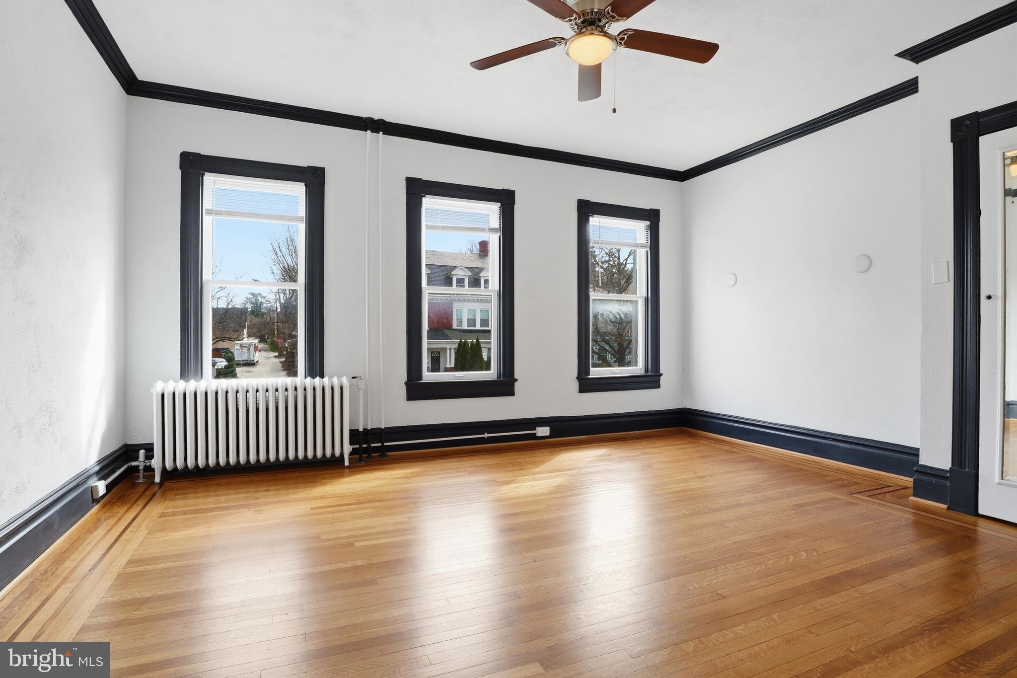 812 South George Street York, PA 17403 - Photo 23 of 58 wooden floor in an empty room with a window