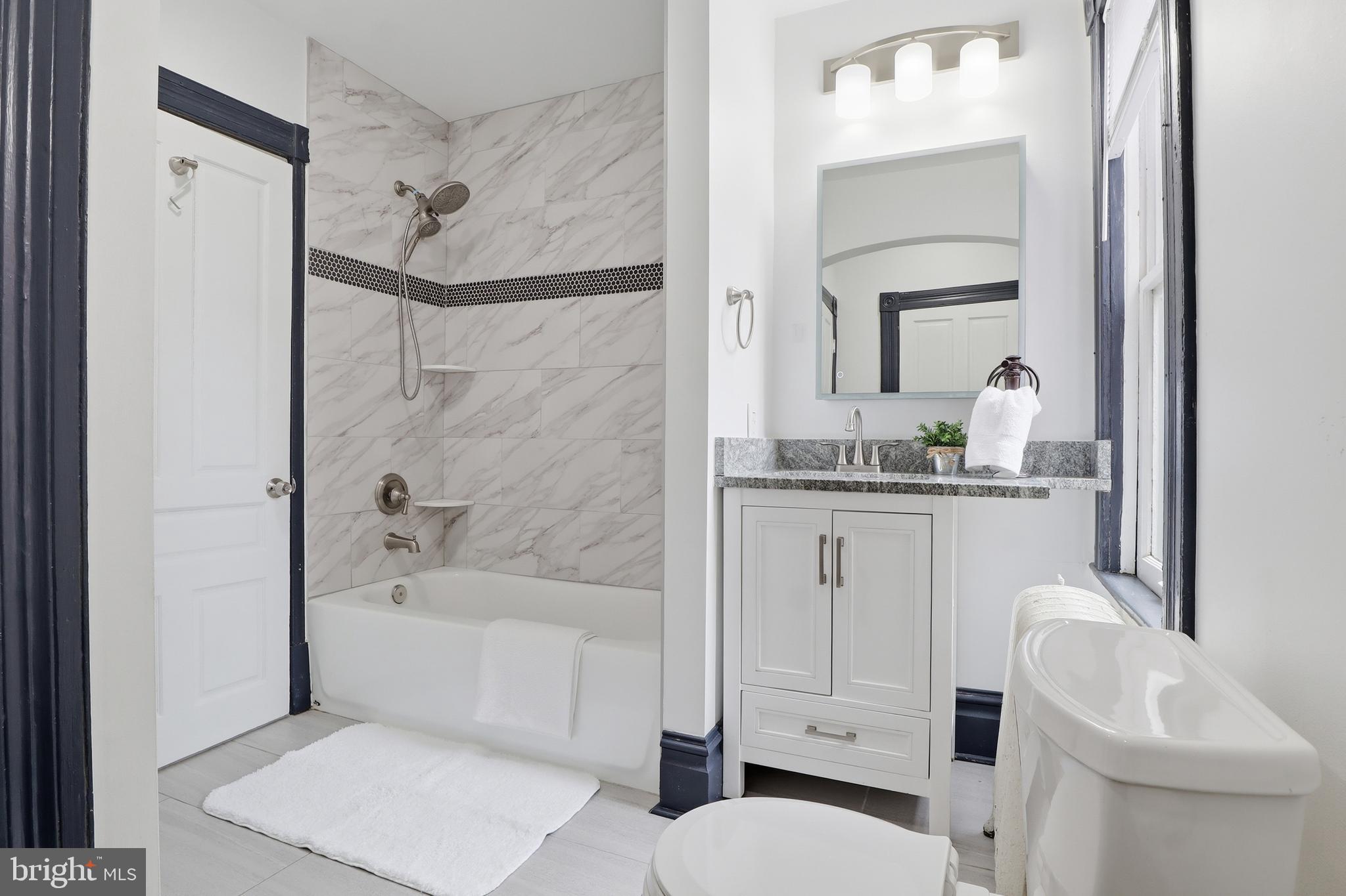 812 South George Street York, PA 17403 - Photo 28 of 58 a bathroom with a sink a toilet and shower