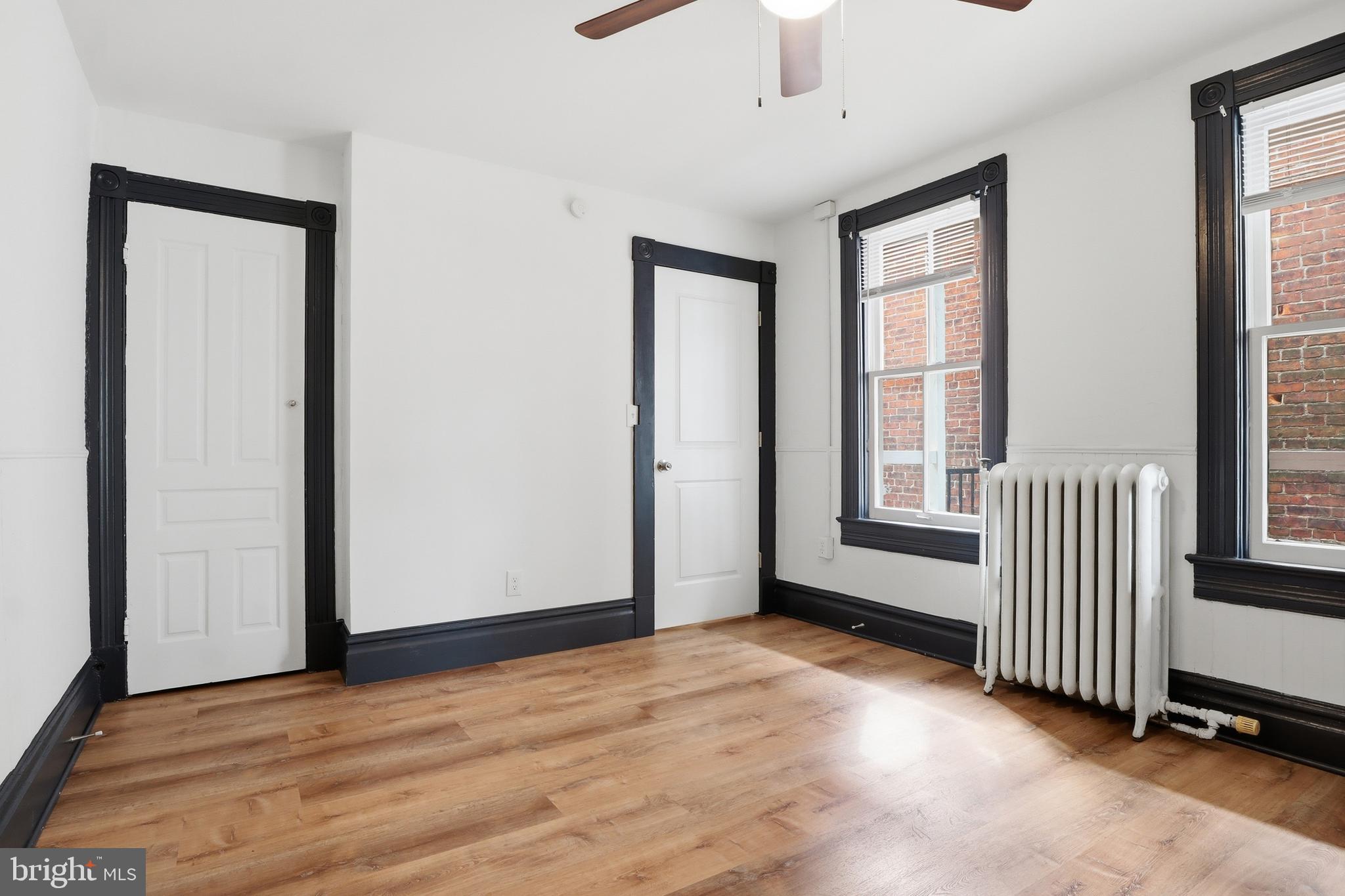 812 South George Street York, PA 17403 - Photo 35 of 58 an empty room with wooden floor and windows