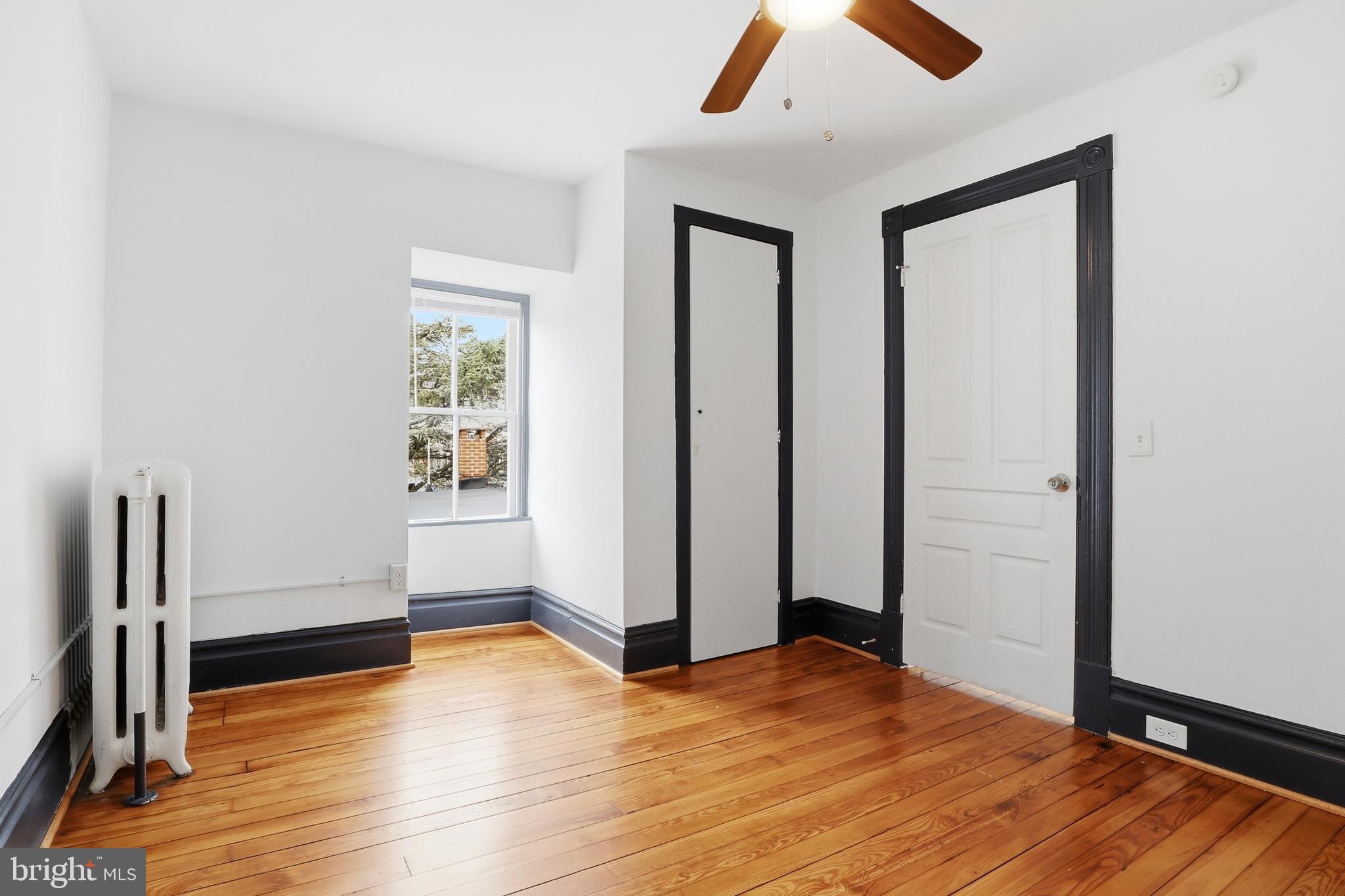 812 South George Street York, PA 17403 - Photo 40 of 58 an empty room with wooden floor closet and windows