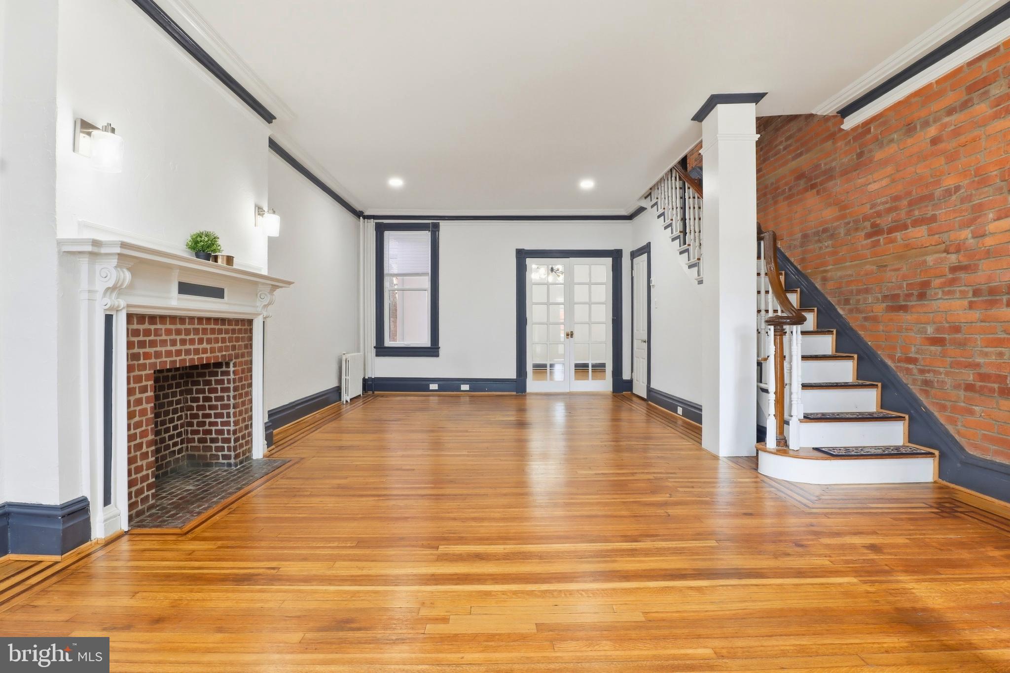 812 South George Street York, PA 17403 - Photo 4 of 58 a view of an empty room with wooden floor fireplace and a window