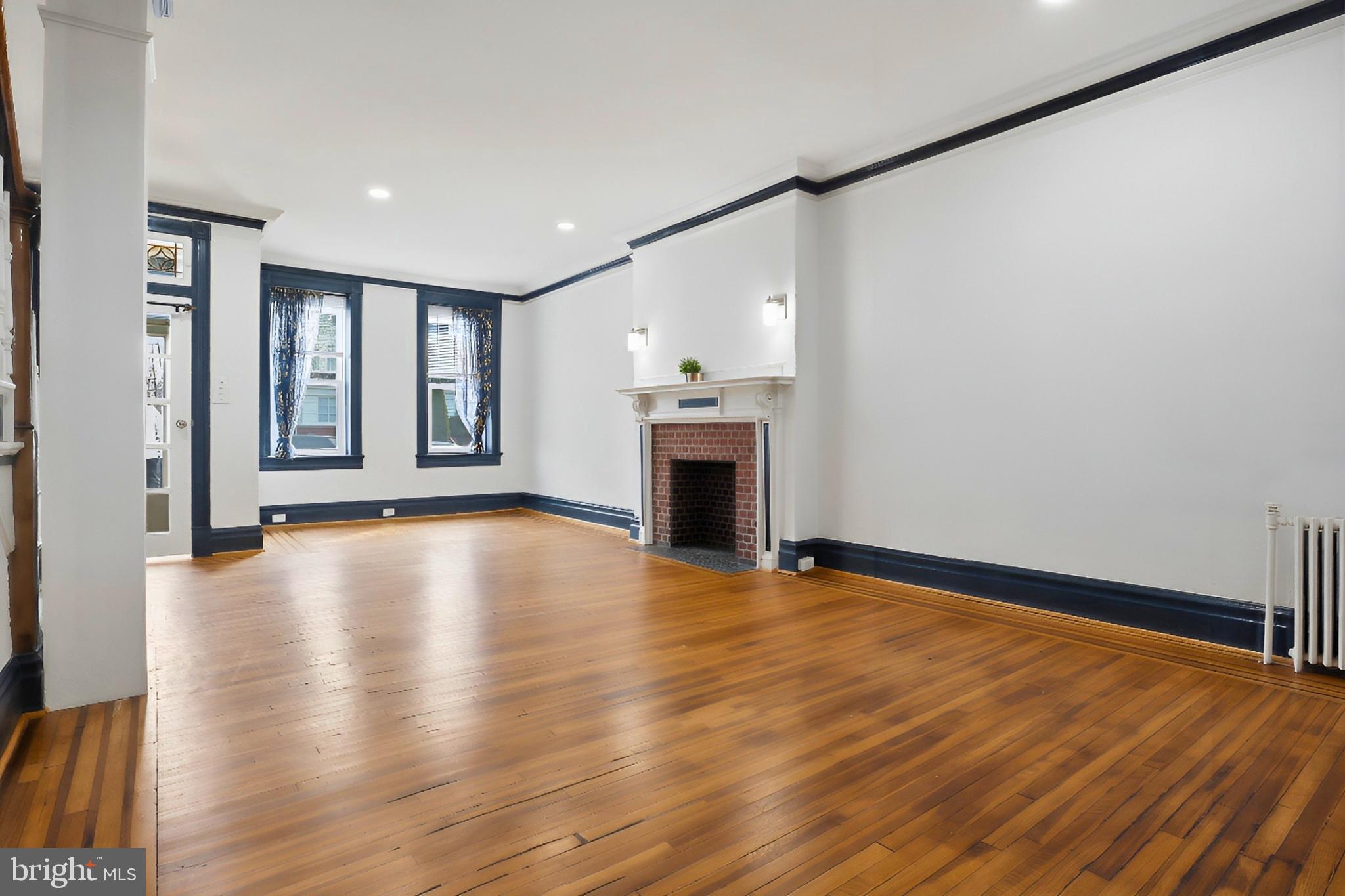 812 South George Street York, PA 17403 - Photo 7 of 58 a view of an empty room with wooden floor and a window