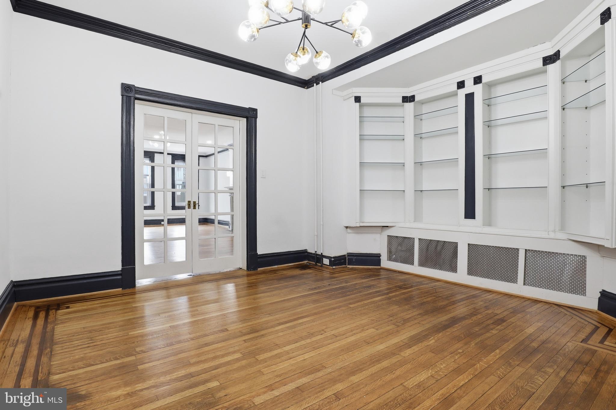812 South George Street York, PA 17403 - Photo 9 of 58 a view of an empty room with wooden floor and a window