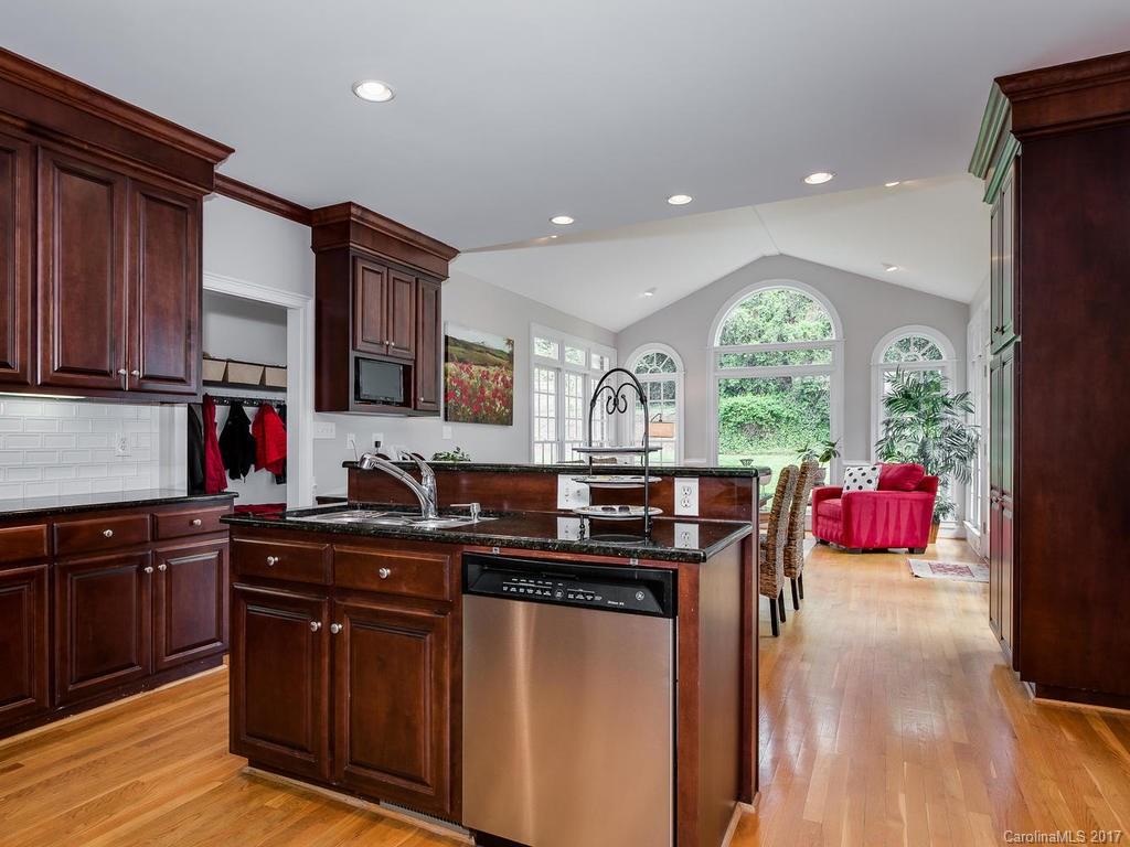 1415 Windy Ridge Road Charlotte, NC 28270 - Photo 11 of 24 a kitchen with stainless steel appliances granite countertop a stove a sink dishwasher and a microwave oven with wooden floor