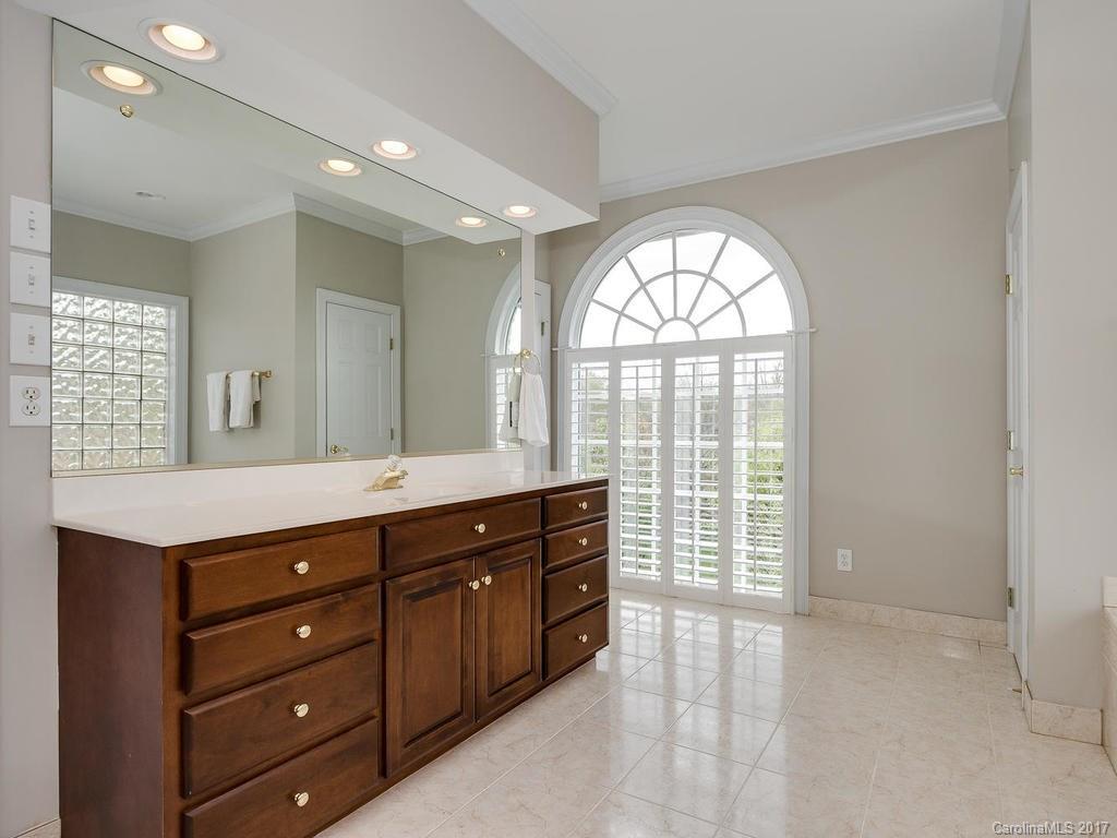 1415 Windy Ridge Road Charlotte, NC 28270 - Photo 14 of 24 a spacious bathroom with a large mirror vanity and a shower