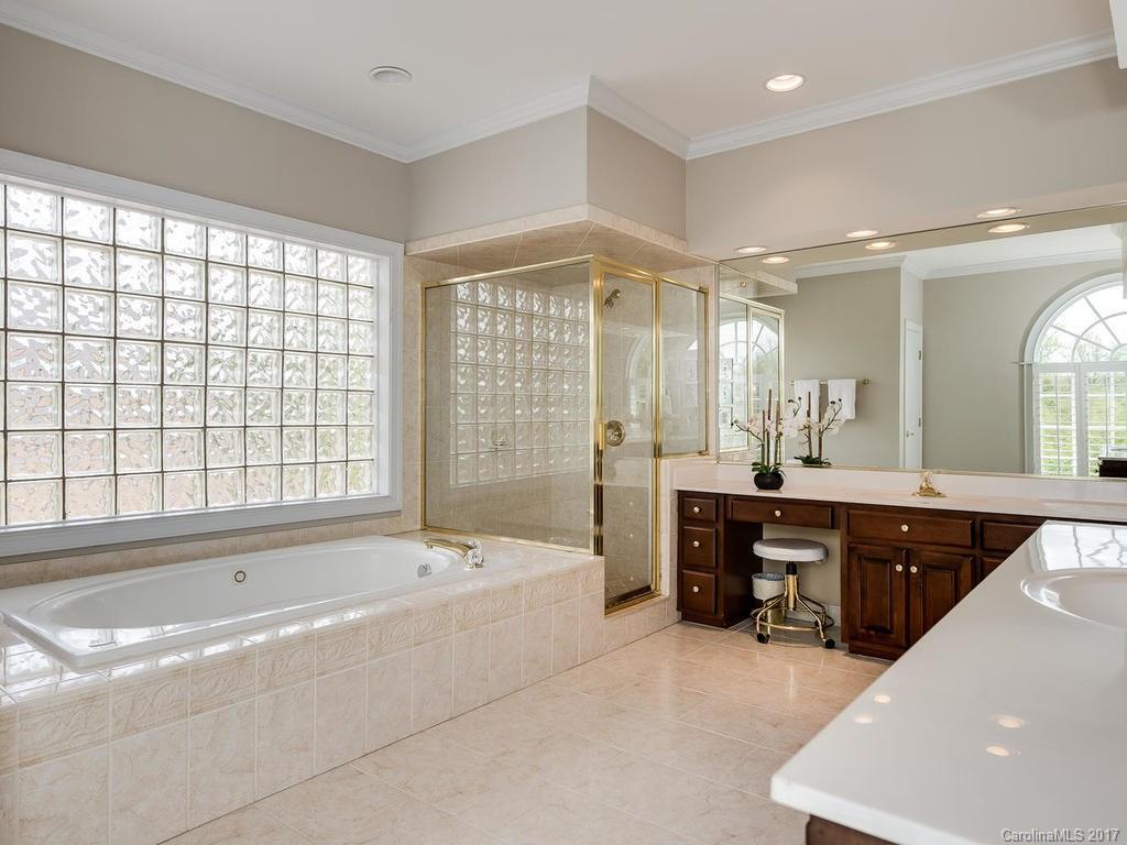 1415 Windy Ridge Road Charlotte, NC 28270 - Photo 15 of 24 a spacious bathroom with a tub sink shower and mirror