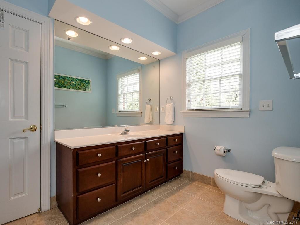 1415 Windy Ridge Road Charlotte, NC 28270 - Photo 17 of 24 a spacious bathroom with a granite countertop toilet sink and mirror