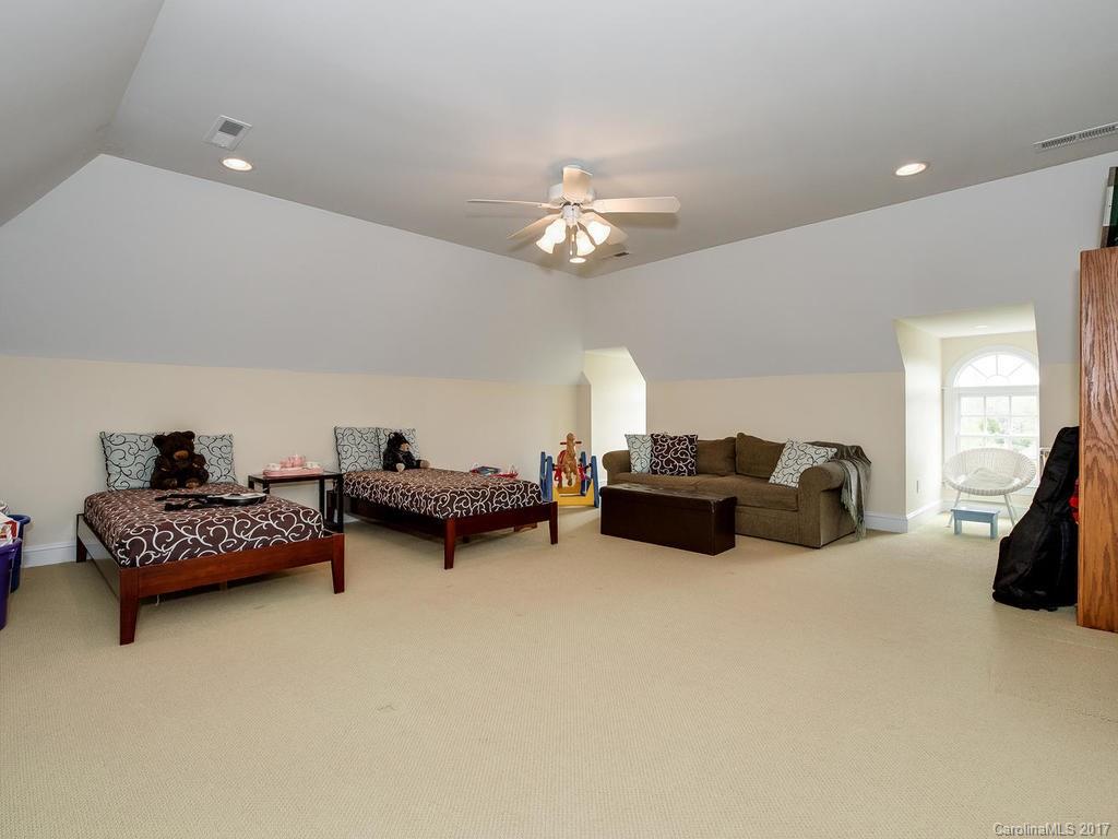 1415 Windy Ridge Road Charlotte, NC 28270 - Photo 21 of 24 a living room with furniture and a chandelier
