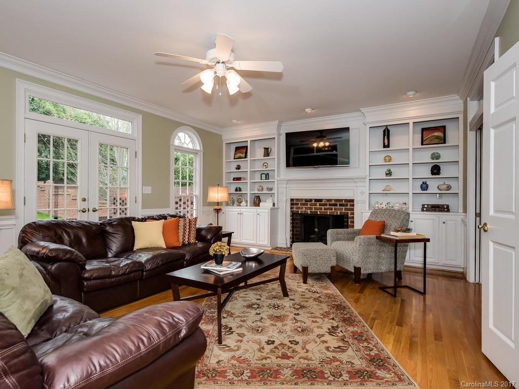 1415 Windy Ridge Road Charlotte, NC 28270 - Photo 7 of 24 a living room with furniture a flat screen tv and a fireplace
