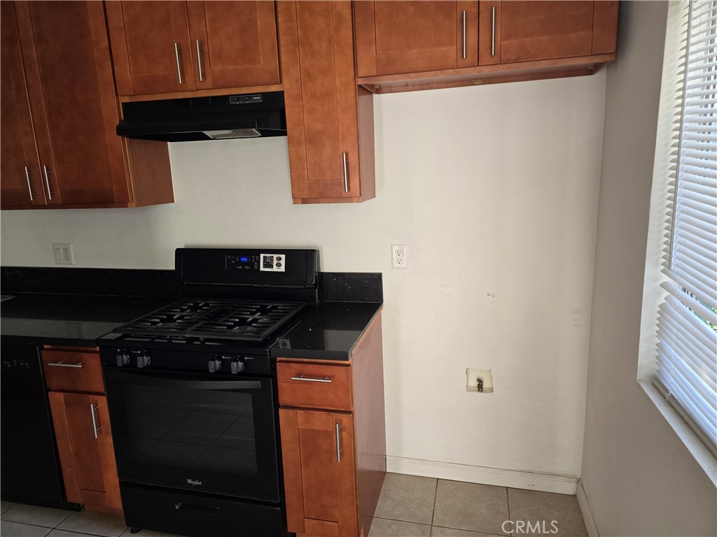 1012 Davis Avenue, Unit B Glendale, CA 91201 - Photo 11 of 11 a kitchen with granite countertop cabinets and black appliances