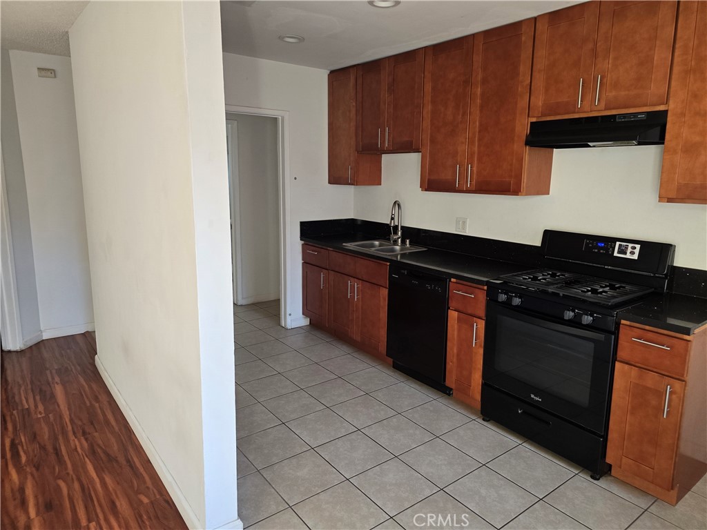 1012 Davis Avenue, Unit B Glendale, CA 91201 - Photo 3 of 11 a kitchen with stainless steel appliances granite countertop a stove a sink and a microwave