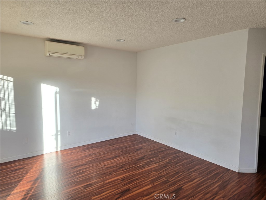 1012 Davis Avenue, Unit B Glendale, CA 91201 - Photo 5 of 11 a view of an empty room with wooden floor and a window