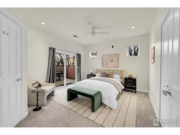 a bedroom with a bed and a large mirror