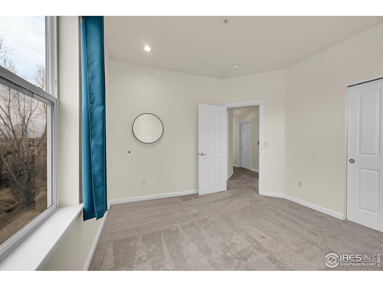 2645 Tabriz Place, Unit 22 Boulder, CO 80304 - Photo 13 of 29 a view of an empty room with window and wooden floor
