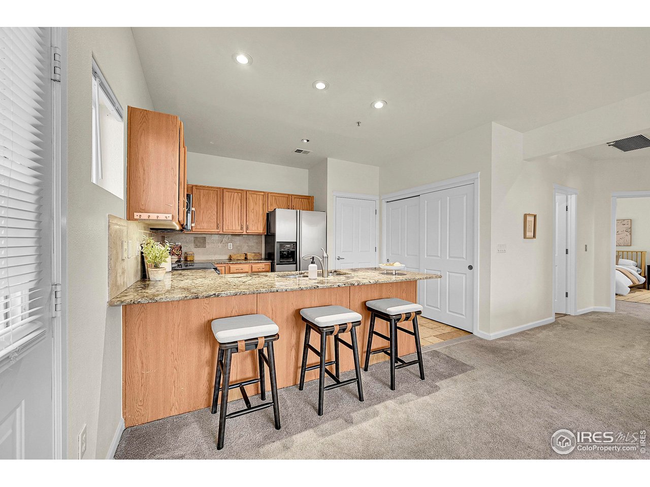 2645 Tabriz Place, Unit 22 Boulder, CO 80304 - Photo 4 of 29 a kitchen with stainless steel appliances granite countertop a table chairs sink and cabinets