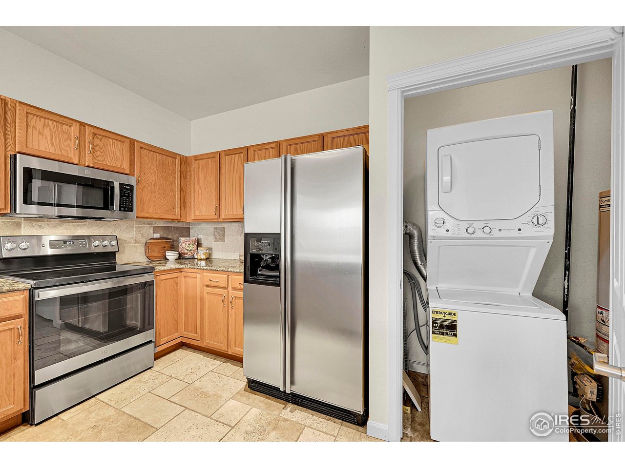 2645 Tabriz Place, Unit 22 Boulder, CO 80304 - Photo 7 of 29 a kitchen with stainless steel appliances granite countertop a refrigerator a stove and a sink with granite countertops