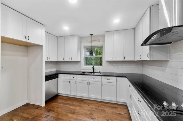 a kitchen that has a sink and cabinets in it